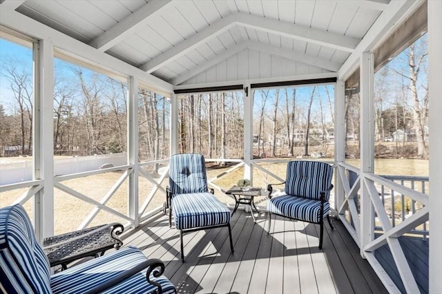 sunroom / solarium with vaulted ceiling with beams