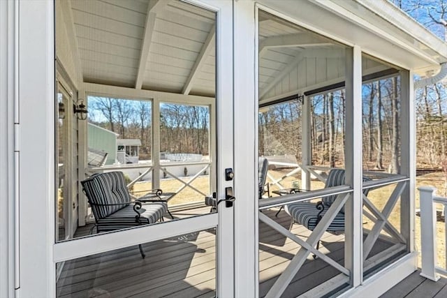 sunroom with lofted ceiling with beams