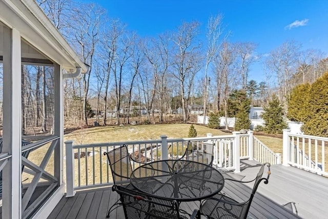 deck with a lawn and outdoor dining space