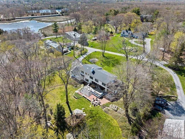 birds eye view of property with a water view and a view of trees