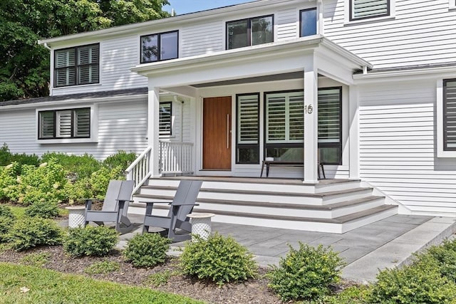 view of exterior entry with covered porch