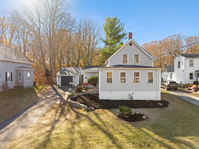 view of side of home with an outbuilding, a garage, and a lawn