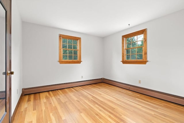 27 Albion Ln, West Newbury, MA 01985 - empty room featuring light wood-type flooring and a baseboard radiator