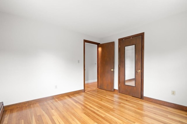 27 Albion Ln, West Newbury, MA 01985 - spare room with light wood-type flooring and a baseboard heating unit
