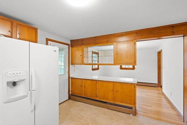27 Albion Ln, West Newbury, MA 01985 - kitchen featuring white fridge with ice dispenser, baseboard heating, light countertops, and brown cabinetry