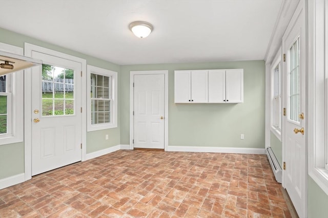 27 Albion Ln, West Newbury, MA 01985 - entrance foyer featuring a baseboard radiator and brick flooring