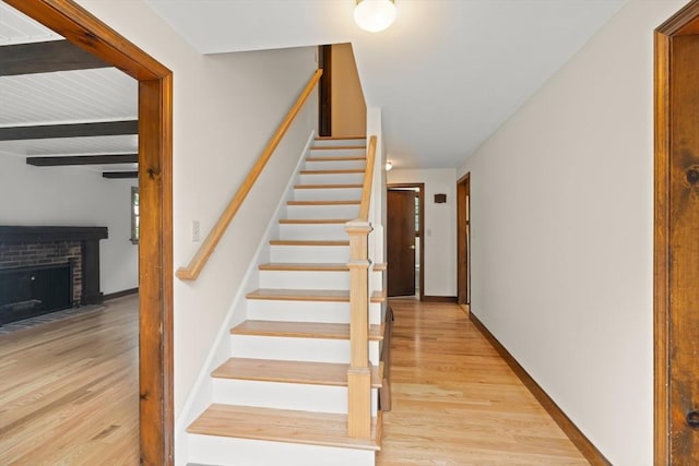 27 Albion Ln, West Newbury, MA 01985 - staircase with wood finished floors and a fireplace