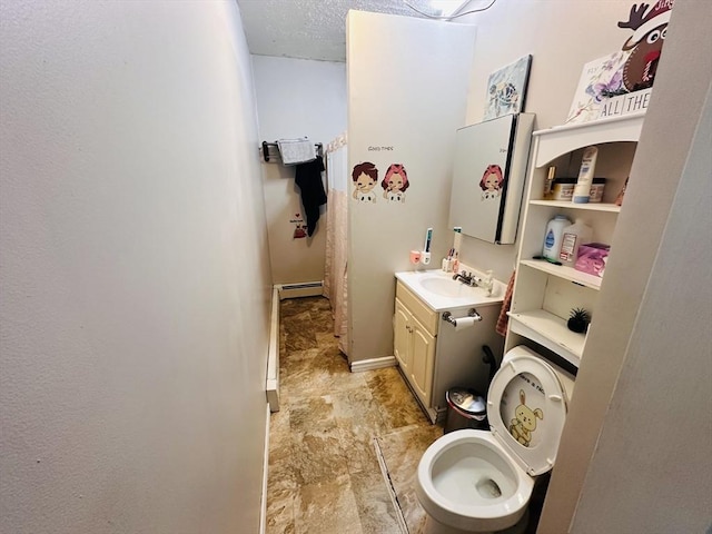 32 Ames St, Worcester, MA 01604 - bathroom with vanity, baseboard heating, and stone finish flooring