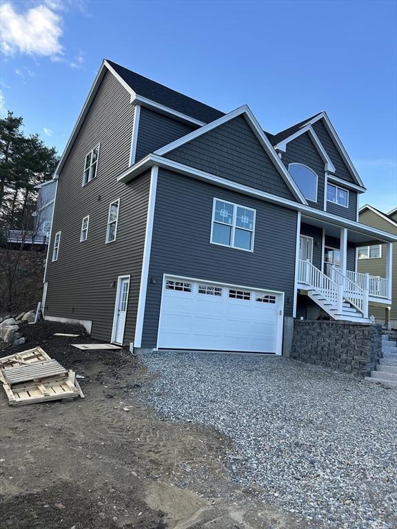 3 Mulligan Unit 3, Kingston, NH 03848 - view of home's exterior featuring a garage, driveway, covered porch, and stairway