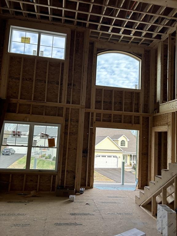 misc room with plenty of natural light and a towering ceiling