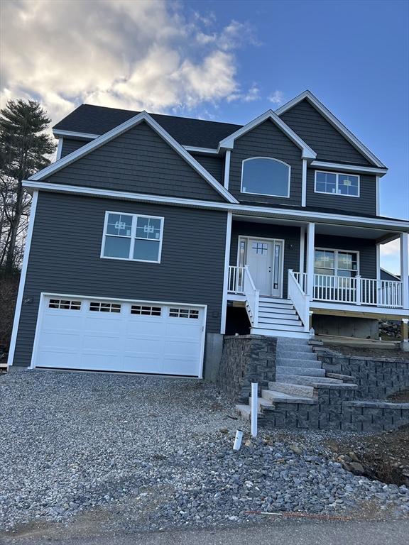 3 Mulligan Unit 3, Kingston, NH 03848 - view of front of house featuring a garage, driveway, and a porch