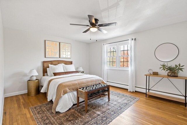 bedroom featuring baseboards, a ceiling fan, and light wood-type flooring