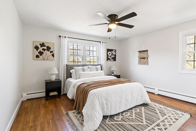 bedroom featuring ceiling fan, baseboard heating, baseboards, a baseboard radiator, and dark wood-type flooring