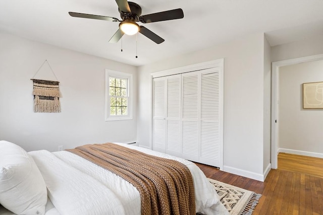 bedroom featuring a closet, baseboards, ceiling fan, and hardwood / wood-style floors
