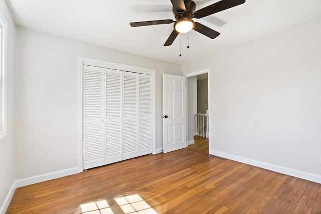 unfurnished bedroom featuring a closet, baseboards, and light wood-style floors