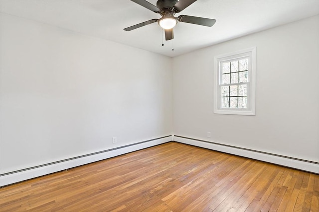empty room featuring wood-type flooring, a ceiling fan, and baseboard heating