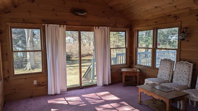 unfurnished sunroom featuring lofted ceiling, wood ceiling, and a wealth of natural light