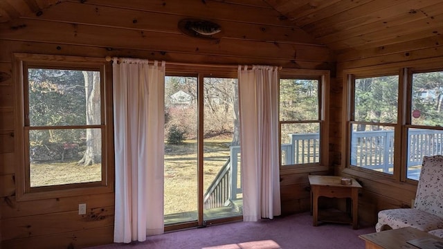 unfurnished sunroom featuring vaulted ceiling