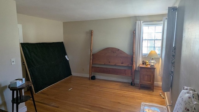 bedroom featuring baseboards and light wood-style floors