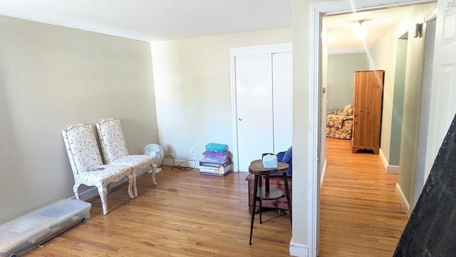 living area with baseboards and light wood-style floors