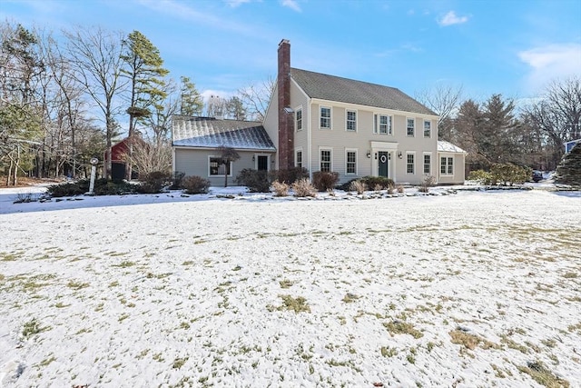 view of snow covered back of property