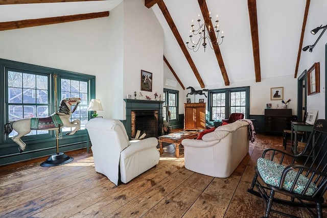 living room with an inviting chandelier, high vaulted ceiling, beamed ceiling, and hardwood / wood-style floors