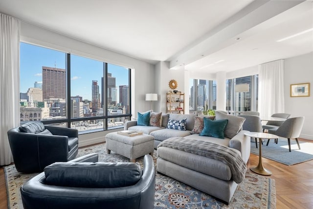 living area with a wealth of natural light, baseboards, and a view of city