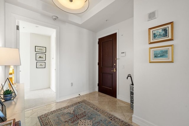 entrance foyer with baseboards, visible vents, and light tile patterned floors