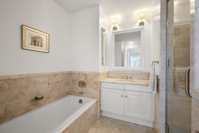 bathroom featuring a bath, vanity, and a shower stall