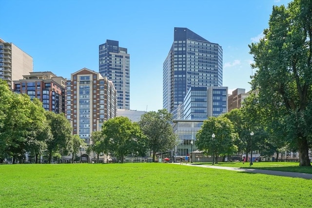 view of property's community featuring a yard and a view of city