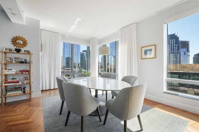 dining area featuring a city view and baseboards