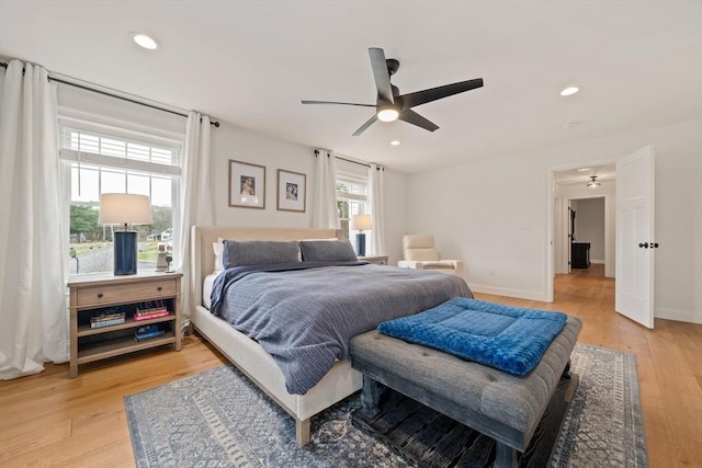 bedroom with recessed lighting, a ceiling fan, and light wood-style flooring