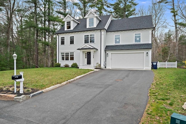 view of front facade with fence, a shingled roof, aphalt driveway, and a garage