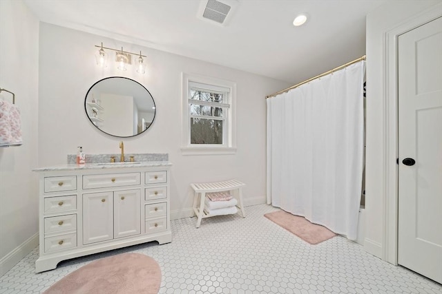 bathroom featuring baseboards, visible vents, a shower with shower curtain, and vanity