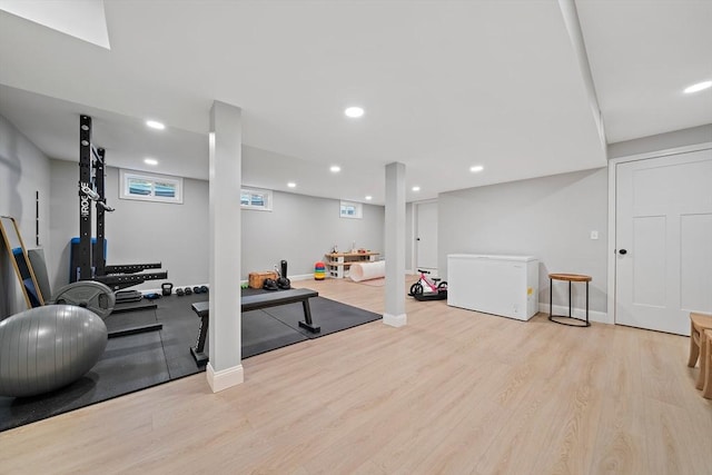 workout room featuring recessed lighting and wood finished floors
