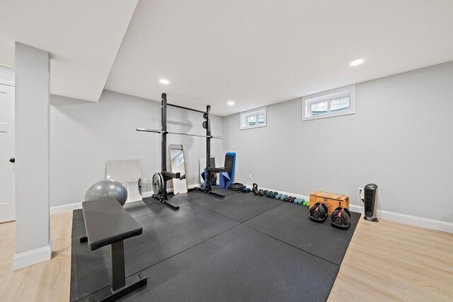 exercise area with recessed lighting, baseboards, and wood finished floors