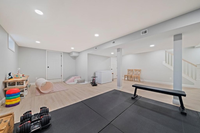 exercise room with baseboards, recessed lighting, wood finished floors, and visible vents