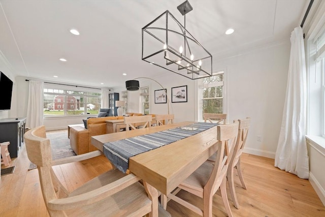dining room featuring a healthy amount of sunlight, recessed lighting, baseboards, and light wood-type flooring