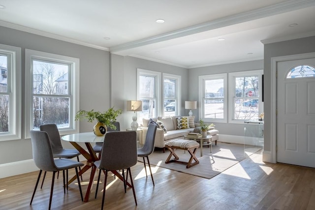 dining area featuring ornamental molding and light wood-type flooring