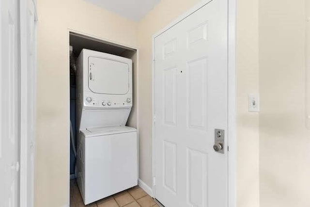 196 Locust Unit 2-508, Lynn, MA 01904 - laundry area featuring stacked washing machine and dryer and light tile patterned floors