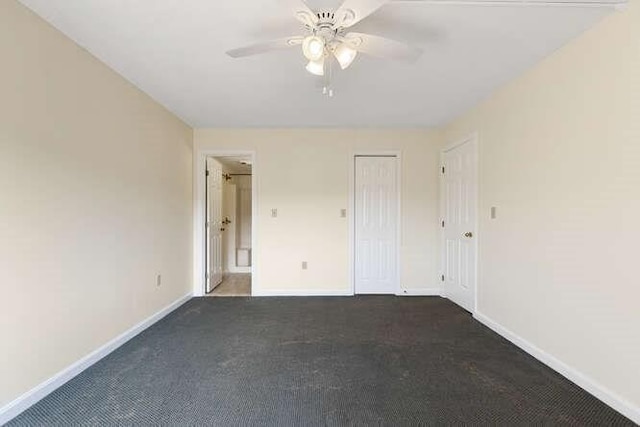 196 Locust Unit 2-508, Lynn, MA 01904 - unfurnished bedroom featuring dark carpet, ensuite bathroom, ceiling fan, and a closet