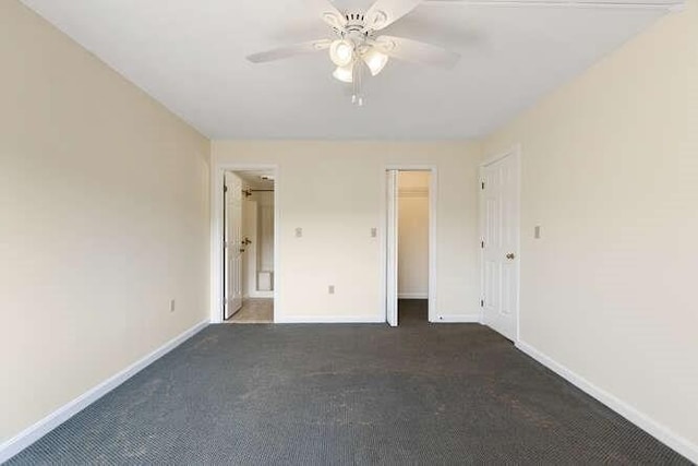 196 Locust Unit 2-508, Lynn, MA 01904 - unfurnished bedroom featuring dark carpet, ensuite bathroom, and ceiling fan