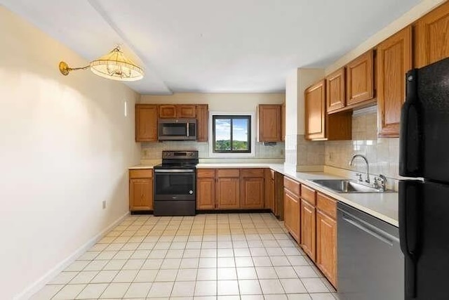 196 Locust Unit 2-508, Lynn, MA 01904 - kitchen with appliances with stainless steel finishes, decorative backsplash, light countertops, and brown cabinetry