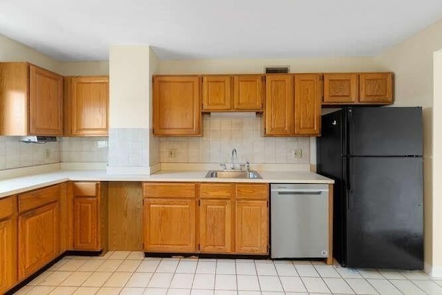 196 Locust Unit 2-508, Lynn, MA 01904 - kitchen featuring stainless steel dishwasher, freestanding refrigerator, tasteful backsplash, and light countertops