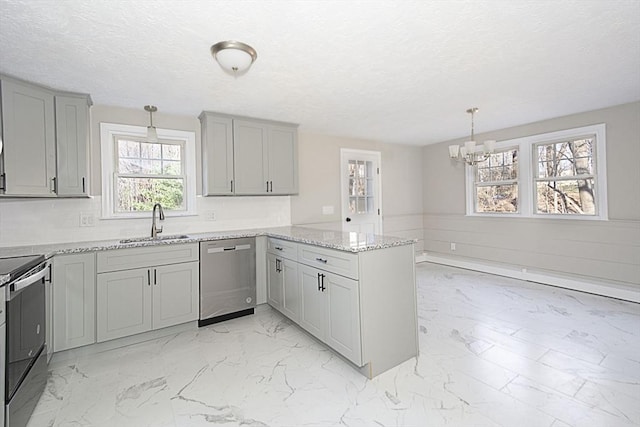 kitchen featuring kitchen peninsula, stainless steel appliances, a wealth of natural light, and sink