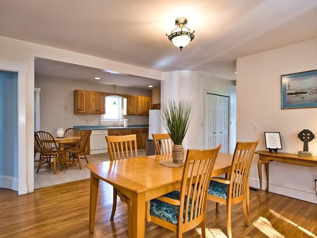 dining space featuring light wood-type flooring