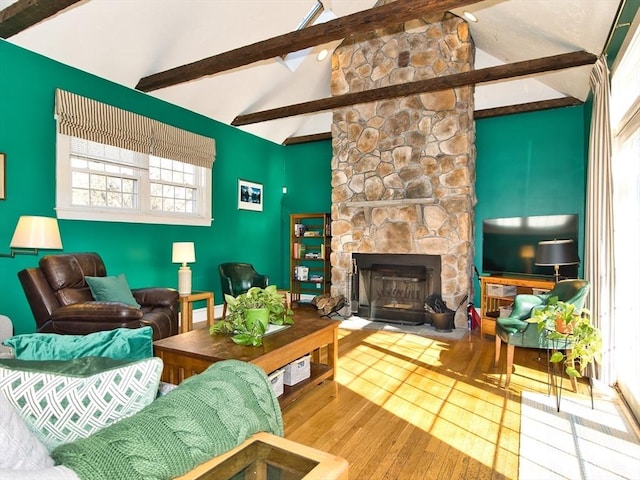 living room with beam ceiling, high vaulted ceiling, hardwood / wood-style floors, and a fireplace