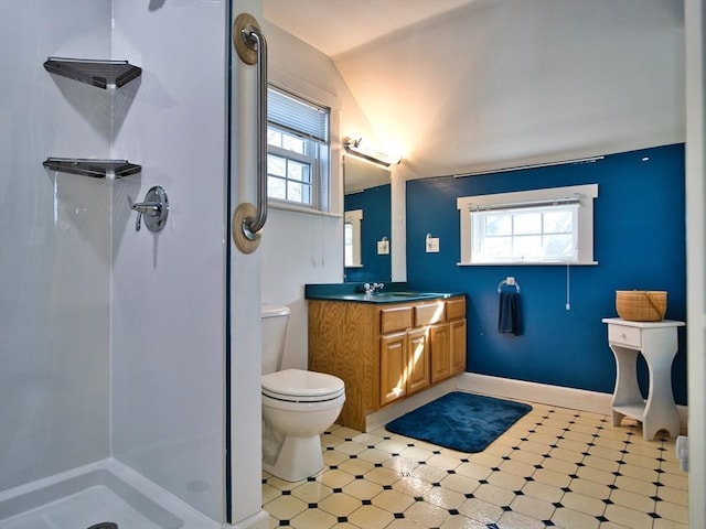 bathroom with a shower, toilet, vaulted ceiling, and vanity