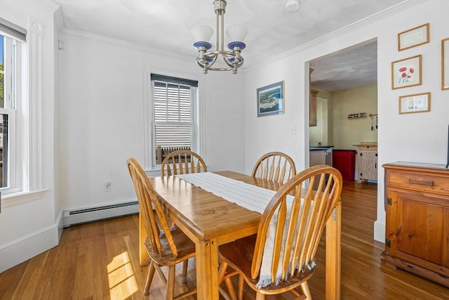 dining area with crown molding, baseboard heating, wood finished floors, and a chandelier
