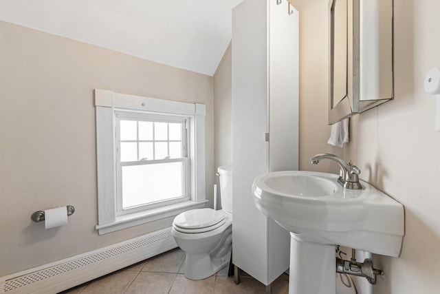 half bathroom featuring toilet, tile patterned floors, baseboard heating, and lofted ceiling